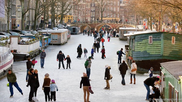 Amsterdam frozen canals, old houseboats